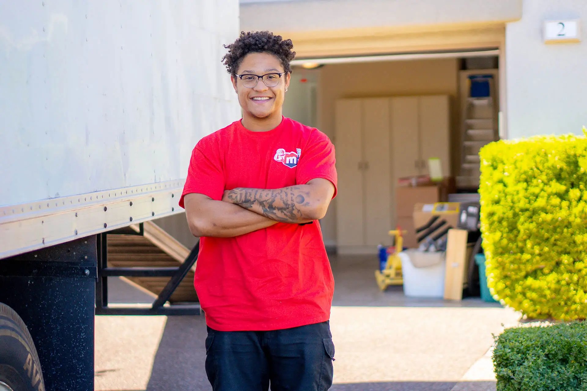 A Muscle Movers crew member standing beside the loaded truck outside a Las Vegas home.