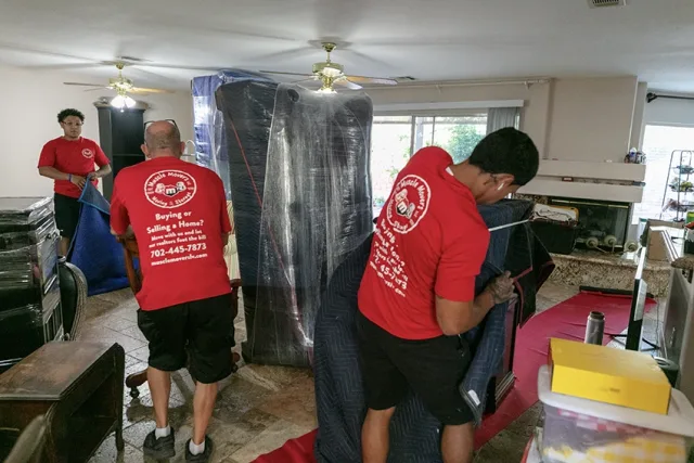 Muscle Movers crew carrying boxes out of a Las Vegas apartment building.