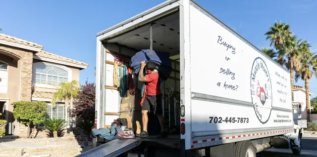 A Muscle Movers truck loading a residential move at a Las Vegas home.