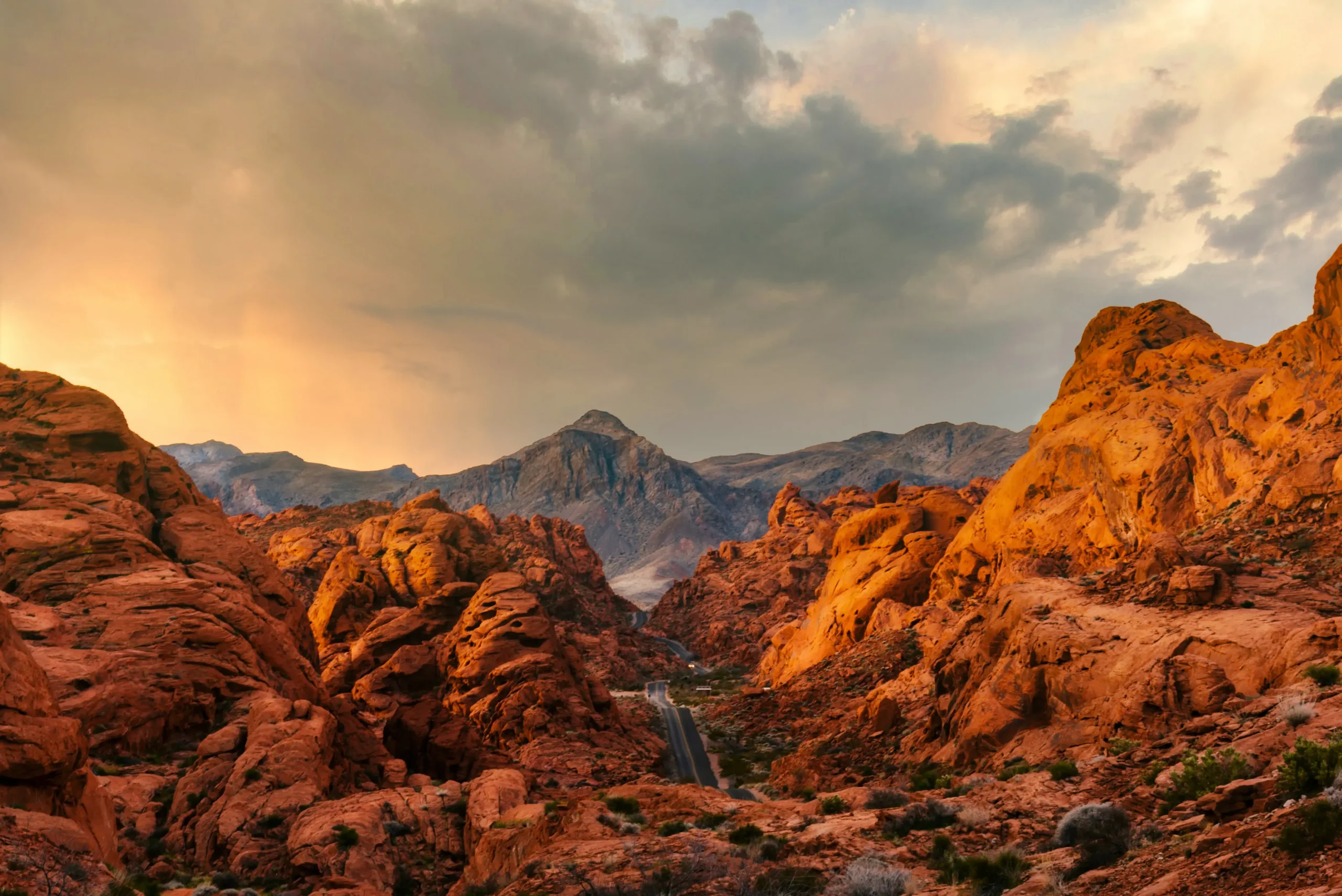 Red rock formations beneath a stormy desert sky.