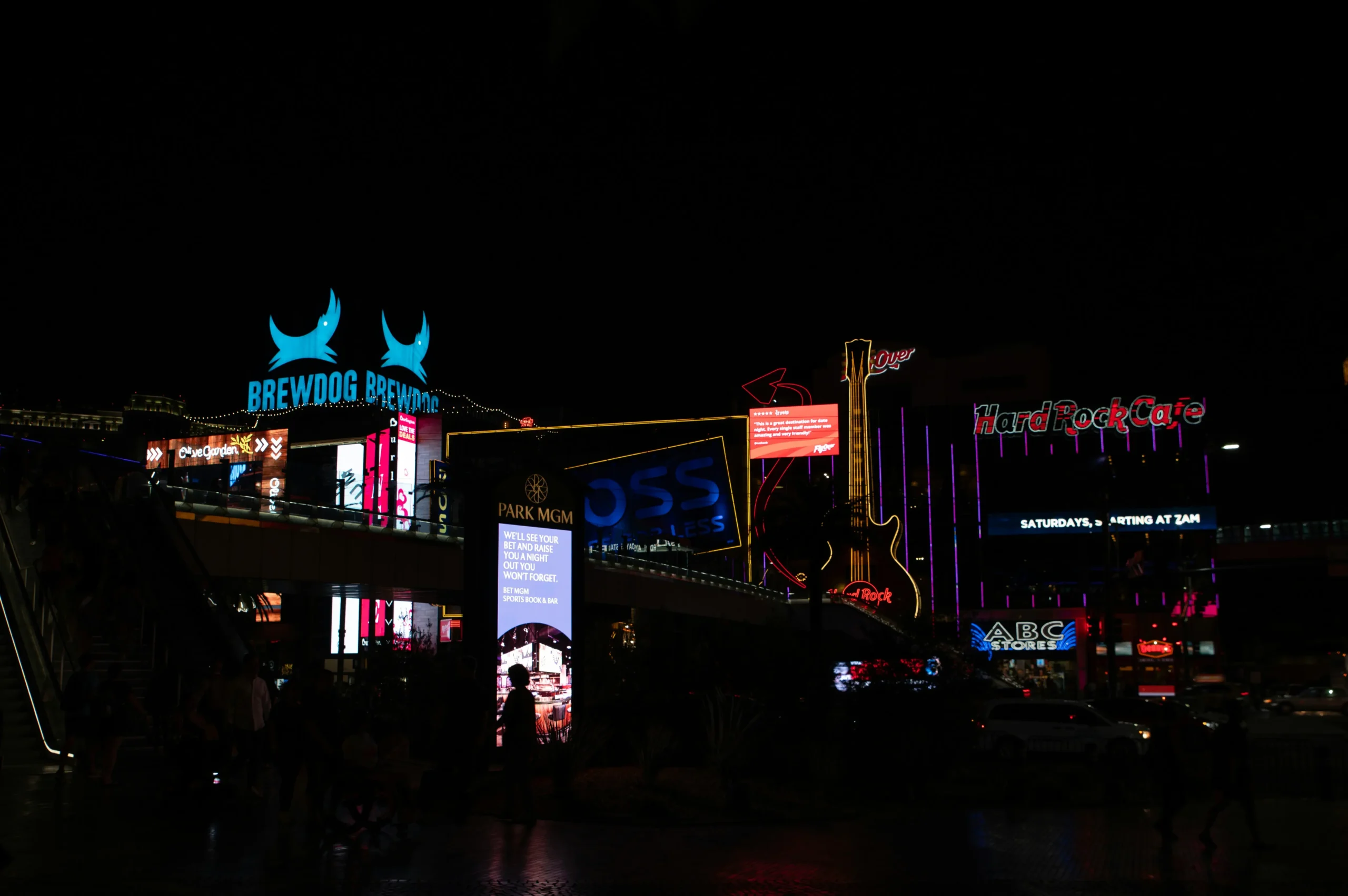 Neon signs lighting up a Las Vegas street at night.